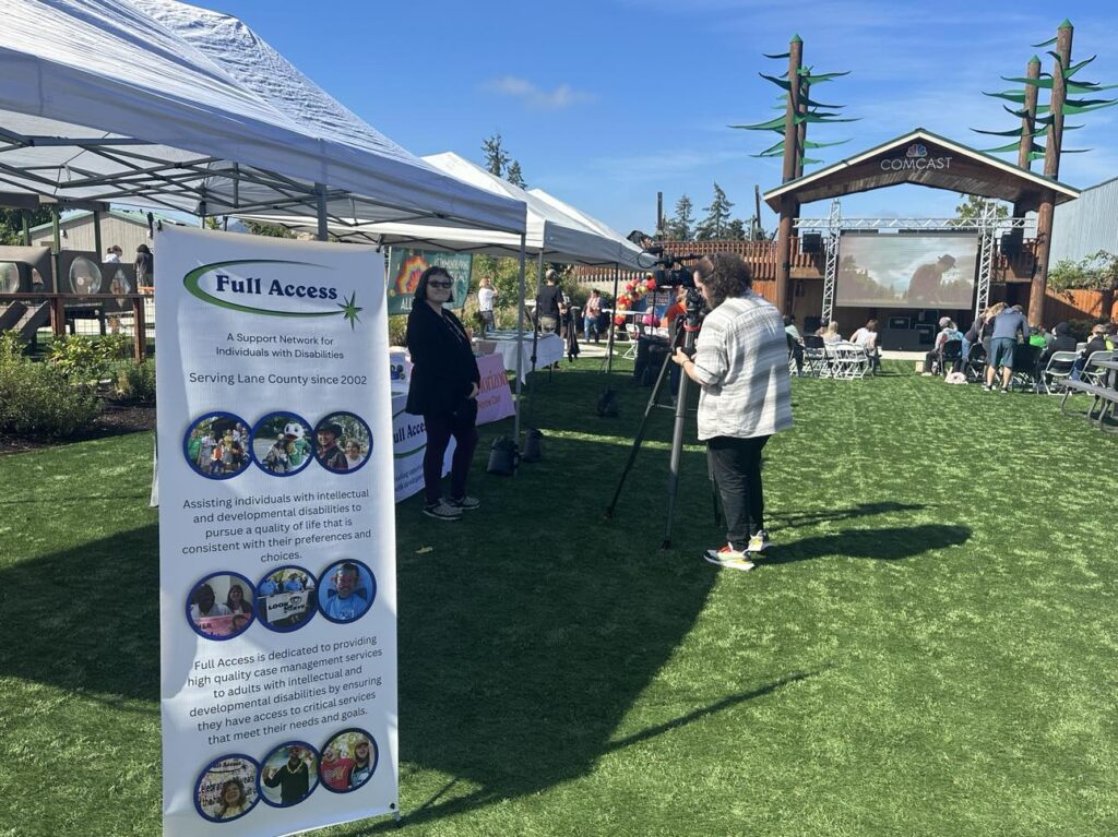 Transition-age student being interviewed by KVAL News at the Sprout Film Festival's matinee showing at Arc Park, promoting inclusion and disability awareness in the community.