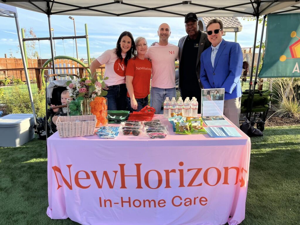 New Horizons representatives at their table during the night showing of the Sprout Film Festival, discussing their mission and support for the disability community
