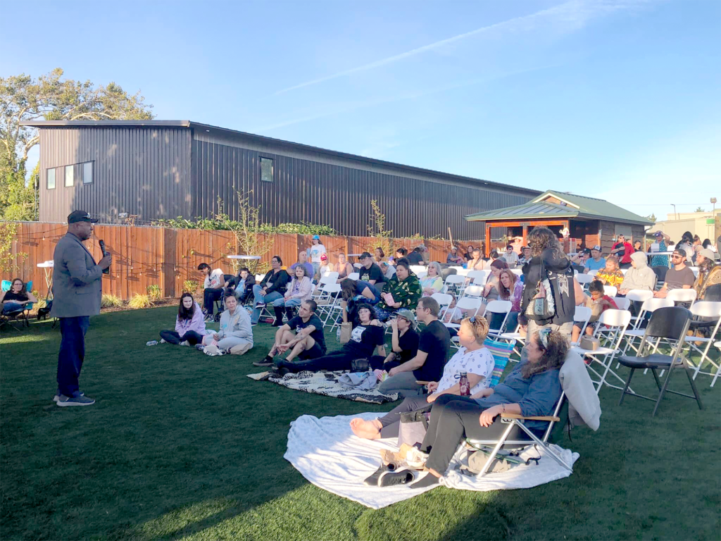 Senator Manning addressing the audience during the night showing of the Sprout Film Festival at Arc Park, emphasizing the importance of community inclusion and disability rights.